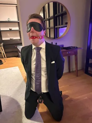 Gagged suited sub