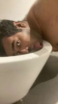 Licking public toilet bowl